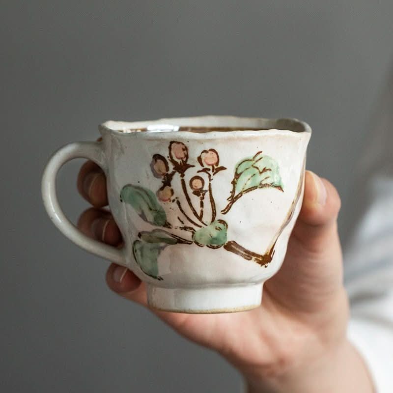 Mino Burning Tang Grass Cherry Blossom cup, hand-painted with pink blossoms & green leaves, Japanese pottery.